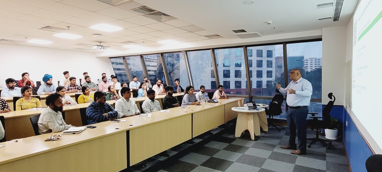Dr. Handa leading a live poll during a corporate financial awareness session
