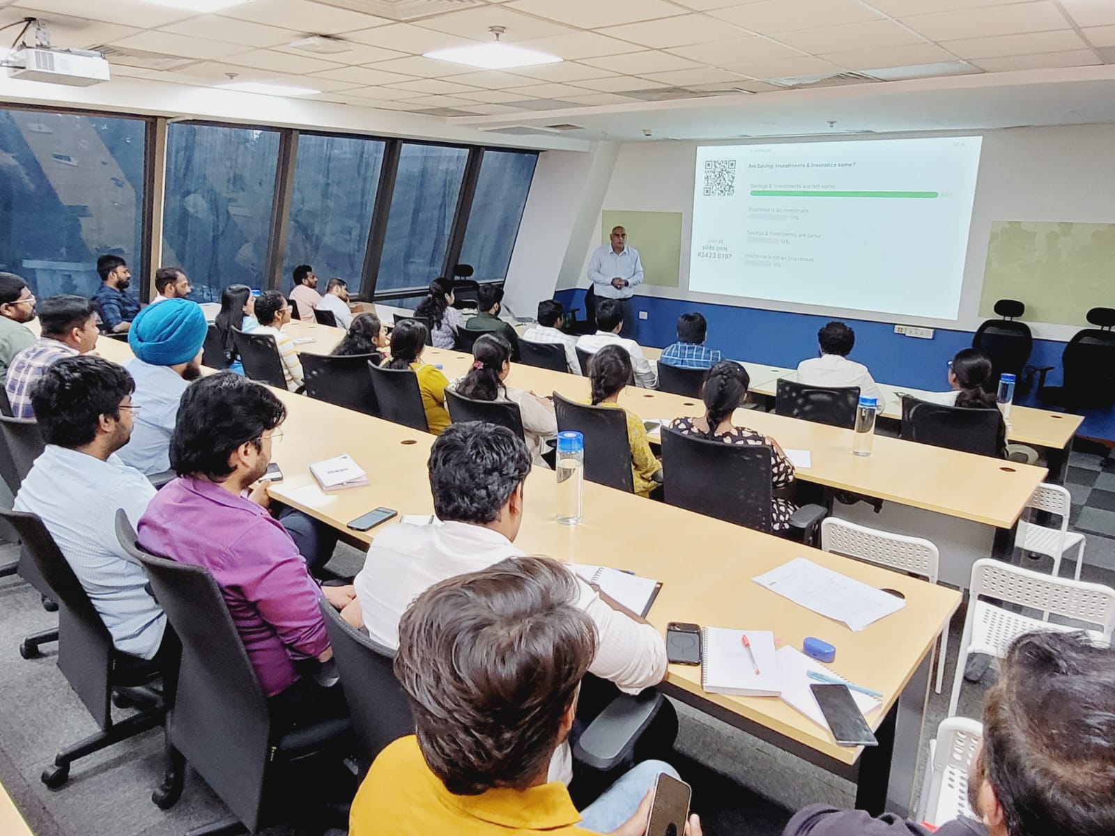 Participants responding to a live poll on savings, investments and insurance